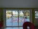 Bright living room featuring a sliding glass door opening to the deck with serene lake views at 3204 W Clinton St, Tampa, FL 33614
