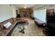 Living room showcasing the stone fireplace, glass block window, and comfortable sectional sofa at 3204 W Clinton St, Tampa, FL 33614