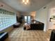 Spacious living room with tile floors, glass block window, and access to the patio at 3204 W Clinton St, Tampa, FL 33614