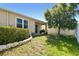 A well-maintained backyard featuring a covered patio, lush lawn, and a decorative stone border at 32853 Woodthrush Way, Wesley Chapel, FL 33545