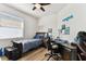 Cozy bedroom with a ceiling fan, a large window, and stylish decor, creating a comfortable and inviting space for rest at 32853 Woodthrush Way, Wesley Chapel, FL 33545