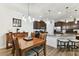 Bright kitchen with a center island, granite countertops, dark cabinetry, and a dining table at 32853 Woodthrush Way, Wesley Chapel, FL 33545