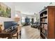 Open-concept living room with views to a dedicated office space, featuring hardwood floors and plenty of natural light at 32853 Woodthrush Way, Wesley Chapel, FL 33545