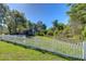 Beautiful backyard featuring a white picket fence, and lush greenery at 37362 Dixie Ave, Dade City, FL 33525