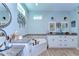 Bright bathroom with a soaking tub, double vanity, granite countertops, white cabinets and wooden floors at 37362 Dixie Ave, Dade City, FL 33525