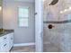 Bathroom featuring a tiled walk-in shower and granite vanity at 37362 Dixie Ave, Dade City, FL 33525
