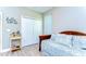 Bright bedroom featuring a cozy daybed and closet with wood-look floors at 37362 Dixie Ave, Dade City, FL 33525