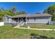 Charming single-story home with a well-manicured lawn and inviting front porch at 37362 Dixie Ave, Dade City, FL 33525