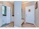 Hallway with laundry room, bench and front door at 37362 Dixie Ave, Dade City, FL 33525