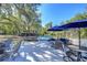 Spacious backyard with various seating options, including chairs, benches, and a hammock at 37410 Dixie Ave, Dade City, FL 33525
