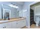 Large bathroom featuring double sink vanity, large mirror and tiled floors at 37410 Dixie Ave, Dade City, FL 33525