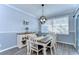 Bright dining room featuring chair rail accents and an updated light fixture at 37410 Dixie Ave, Dade City, FL 33525