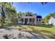 Charming two-story home with a welcoming front porch and mature landscaping, perfect for relaxing and enjoying the outdoors at 37410 Dixie Ave, Dade City, FL 33525