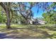 Quaint home with an extended driveway and garage, framed by mature trees, blending curb appeal with countryside charm at 37410 Dixie Ave, Dade City, FL 33525