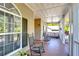 Relaxing front porch featuring rocking chairs, a porch swing, and views of the lush yard at 37410 Dixie Ave, Dade City, FL 33525