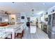 Open concept kitchen with stainless steel appliances, granite countertops, and breakfast bar seating at 37410 Dixie Ave, Dade City, FL 33525