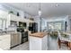 Bright kitchen featuring stainless appliances, butcher block island, with adjacent dining area at 37410 Dixie Ave, Dade City, FL 33525