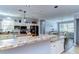 Spacious kitchen featuring granite counters, stainless steel appliances, and an island with seating and wooden countertop at 37410 Dixie Ave, Dade City, FL 33525