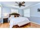 Calm main bedroom with a wood-framed bed, wood floors, and an overhead fan at 37410 Dixie Ave, Dade City, FL 33525