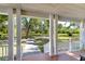 Spacious porch with white columns and railings, providing a serene outdoor space to enjoy the beautiful natural surroundings at 37410 Dixie Ave, Dade City, FL 33525