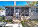 Rear view of home with a screened porch and a wood access stairway at 37410 Dixie Ave, Dade City, FL 33525