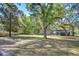Spacious backyard with lush lawn, offering ample room for recreation and outdoor activities in a serene setting at 37410 Dixie Ave, Dade City, FL 33525
