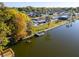 Aerial view showcasing the home's waterfront location with a dock and lush landscaping, highlighting its peaceful setting at 3814 Sunray Dr, Holiday, FL 34691