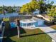 Aerial view of this property featuring a manicured lawn, covered front porch, and water views at 3814 Sunray Dr, Holiday, FL 34691