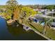Aerial view of a waterfront single-Gathering home with mature trees and boat dock at 3814 Sunray Dr, Holiday, FL 34691
