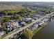 A vibrant waterfront community with mature trees and well-kept homes, aerial view at 3814 Sunray Dr, Holiday, FL 34691