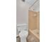 Cozy bathroom featuring a toilet and tiled shower with neutral colors, providing essential amenities at 3814 Sunray Dr, Holiday, FL 34691
