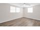 Clean, bright bedroom with ample natural light, ceiling fan, and wood-look flooring at 3814 Sunray Dr, Holiday, FL 34691