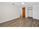 Bedroom featuring modern ceiling fan, wood look floors, closet, and neutral paint at 3814 Sunray Dr, Holiday, FL 34691