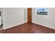 Cozy bedroom featuring a picturesque window view and luxury vinyl plank flooring at 3814 Sunray Dr, Holiday, FL 34691