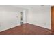 This simple bedroom features luxury vinyl plank flooring and neutral decor at 3814 Sunray Dr, Holiday, FL 34691