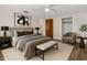 Cozy bedroom featuring a queen bed, stylish decor, closet, and ensuite for ultimate convenience at 3814 Sunray Dr, Holiday, FL 34691