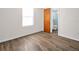 Bright bedroom with wood-look floors and an en-suite bathroom for added convenience at 3814 Sunray Dr, Holiday, FL 34691