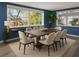 Dining room featuring a large wooden table, cushioned chairs, and scenic views from the large windows at 3814 Sunray Dr, Holiday, FL 34691