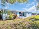 Charming home featuring a well-maintained lawn and tasteful landscaping at 3814 Sunray Dr, Holiday, FL 34691