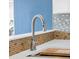 Modern kitchen with stainless steel faucet, subway tile backsplash, and quartz countertop at 3814 Sunray Dr, Holiday, FL 34691
