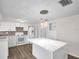 Renovated kitchen with new appliances, a white island, and sleek design, creating a modern and functional space at 3814 Sunray Dr, Holiday, FL 34691