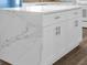 Close-up of kitchen island with white cabinets and beautiful marble countertop at 3814 Sunray Dr, Holiday, FL 34691