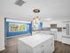 Beautiful kitchen with an island, white cabinets, modern appliances, and wood floors, offering a stylish cooking space at 3814 Sunray Dr, Holiday, FL 34691