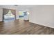 Open-concept living room with views into the kitchen and screened in porch at 3814 Sunray Dr, Holiday, FL 34691