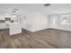Open-concept living area with wood floors, natural light, and seamless transition to the kitchen, perfect for entertaining at 3814 Sunray Dr, Holiday, FL 34691