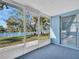 Enclosed sunroom with sliding doors and view of the canal at 3814 Sunray Dr, Holiday, FL 34691