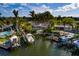 Aerial view of a waterfront property featuring a private dock, boat lift, and swimming pool at 3960 13Th Ne Way, St Petersburg, FL 33703