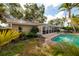 Secluded backyard featuring a sparkling pool, lush greenery, and ample space for outdoor relaxation and entertaining at 3960 13Th Ne Way, St Petersburg, FL 33703