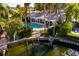 Waterfront home featuring a private pool, dock, and serene views of the water and lush greenery at 3960 13Th Ne Way, St Petersburg, FL 33703