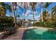 The crystal-clear pool is accompanied by an outdoor dining area overlooking a picturesque canal at 3960 13Th Ne Way, St Petersburg, FL 33703